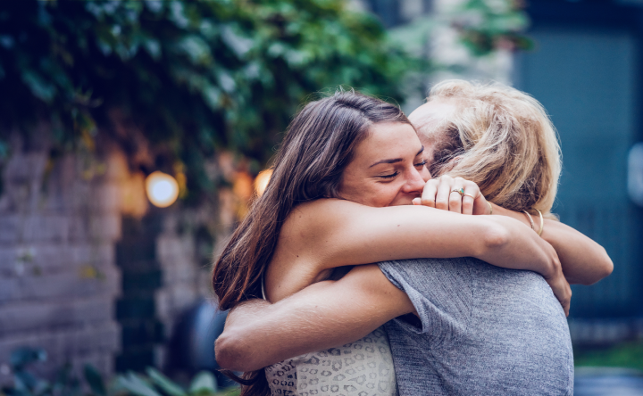 Two women embracing with a hug