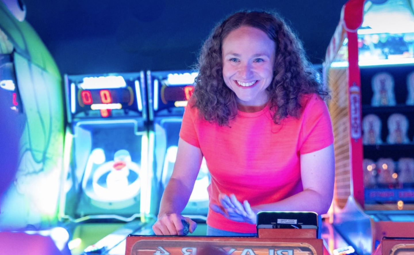Casandra, a TZIELD® (teplizumab-mzwv) patient, smiling while playing a game at a carnival