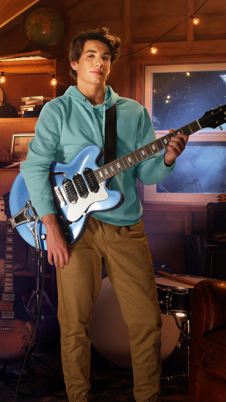 Image of a teenage boy playing guitar